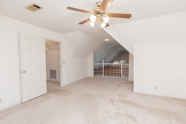 bonus room with a textured ceiling, ceiling fan, light carpet, and lofted ceiling