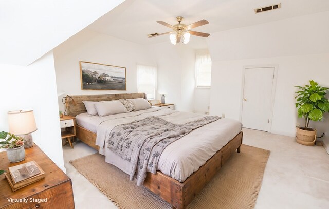 carpeted bedroom featuring ceiling fan and vaulted ceiling