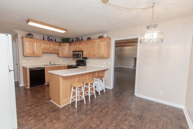 kitchen with a textured ceiling, sink, black appliances, decorative light fixtures, and dark hardwood / wood-style floors