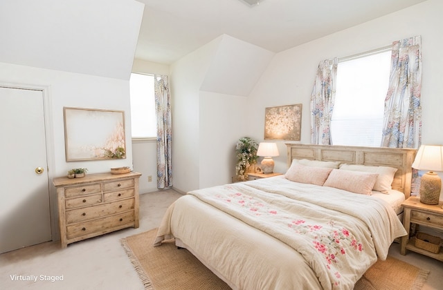 carpeted bedroom featuring vaulted ceiling