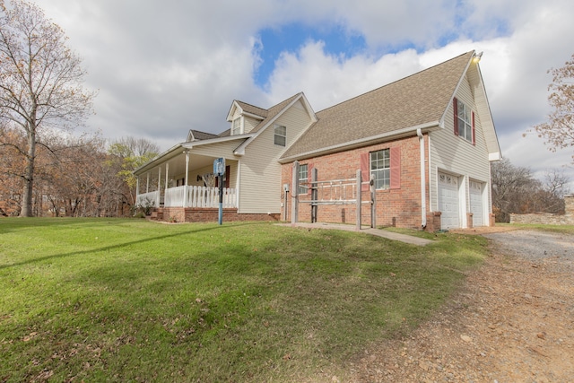 view of front of home featuring a front lawn, a porch, and a garage