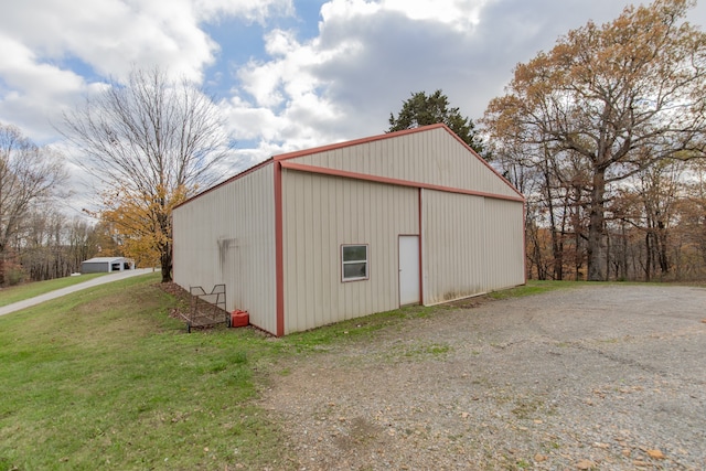 view of outbuilding featuring a lawn