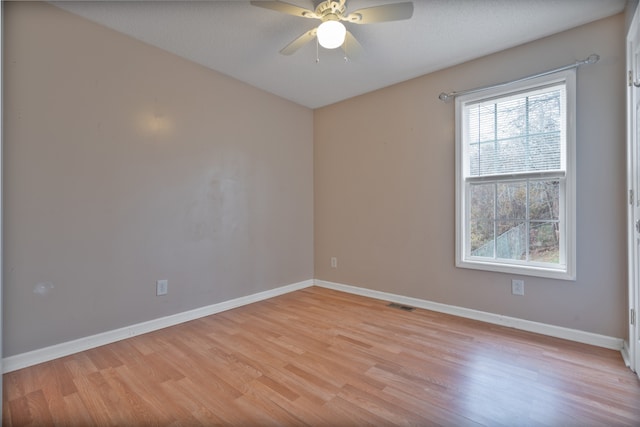 empty room featuring a textured ceiling, light hardwood / wood-style floors, and ceiling fan