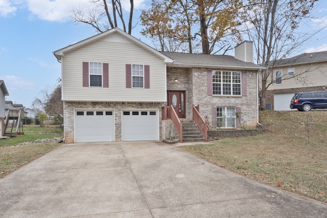 bi-level home featuring a front yard and a garage