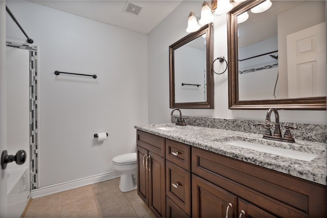 bathroom with tile patterned floors, vanity, and toilet