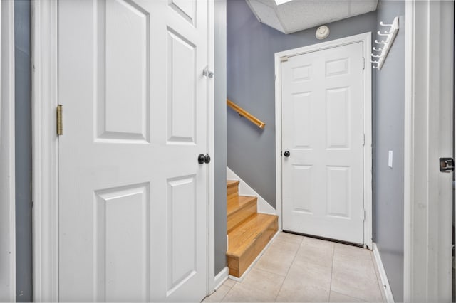 doorway to outside with light tile patterned flooring