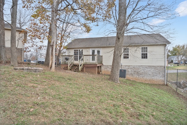 back of house with a lawn, a deck, and french doors