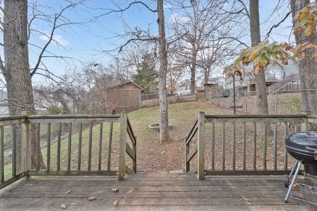 deck featuring a lawn and area for grilling