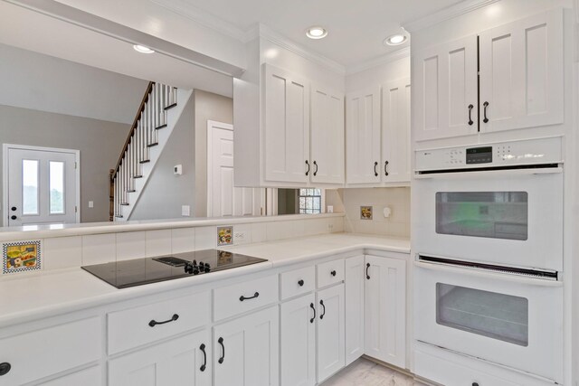 1055 Wades Branch Rd, Centerville, TN 37033 - kitchen featuring white double oven, black electric cooktop, white cabinets, light countertops, and recessed lighting