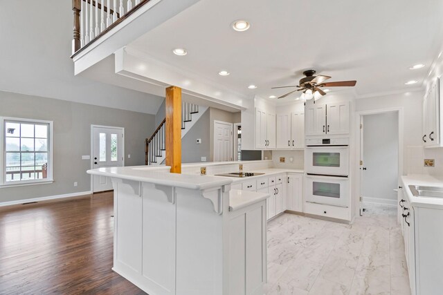 1055 Wades Branch Rd, Centerville, TN 37033 - kitchen with a peninsula, ceiling fan, black electric cooktop, white cabinets, and recessed lighting
