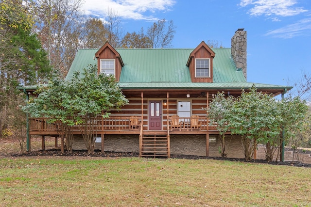 1055 Wades Branch Rd, Centerville, TN 37033 - log-style house featuring stairs, a front yard, a chimney, metal roof, and covered porch
