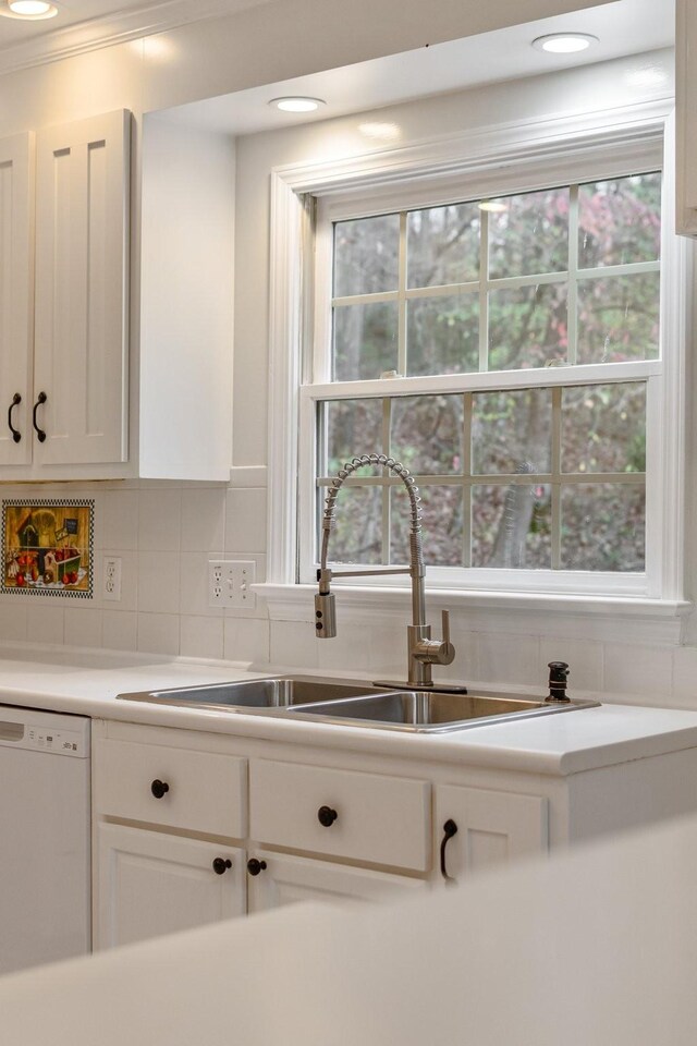 1055 Wades Branch Rd, Centerville, TN 37033 - kitchen featuring white dishwasher, a sink, backsplash, white cabinets, and light countertops