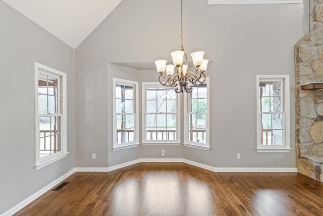 1055 Wades Branch Rd, Centerville, TN 37033 - empty room with a chandelier, dark wood-style floors, high vaulted ceiling, and baseboards