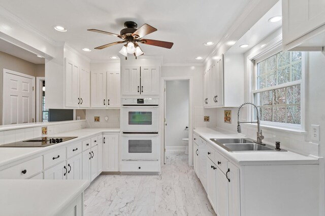 1055 Wades Branch Rd, Centerville, TN 37033 - kitchen featuring white double oven, a sink, black electric cooktop, white cabinets, and recessed lighting