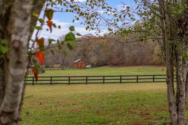 1055 Wades Branch Rd, Centerville, TN 37033 - view of yard with a barn, a view of rural / pastoral area, an outdoor structure, and a forest view