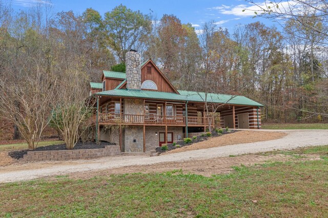 1055 Wades Branch Rd, Centerville, TN 37033 - log home featuring stone siding, driveway, a chimney, metal roof, and a deck