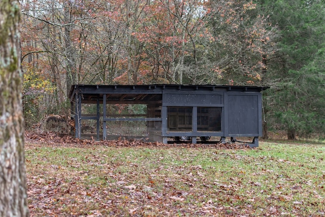 view of outbuilding featuring a lawn