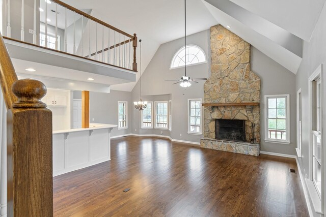 1055 Wades Branch Rd, Centerville, TN 37033 - unfurnished living room with a chandelier, ceiling fan, dark wood-style floors, high vaulted ceiling, and a fireplace
