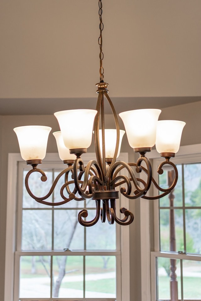 interior details featuring an inviting chandelier