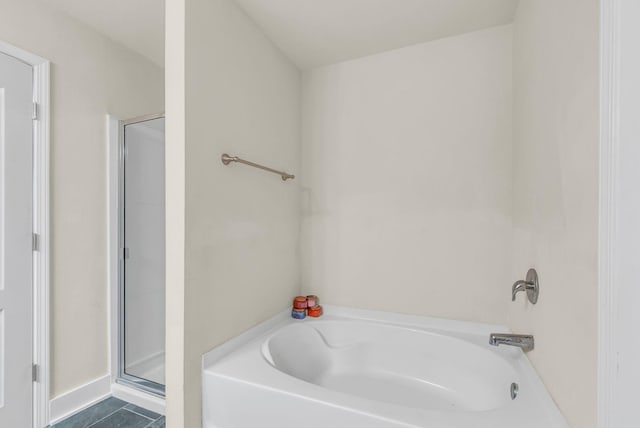 bathroom featuring tile patterned flooring and independent shower and bath