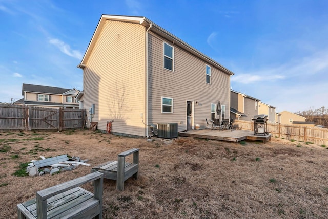 rear view of house with a wooden deck and central AC