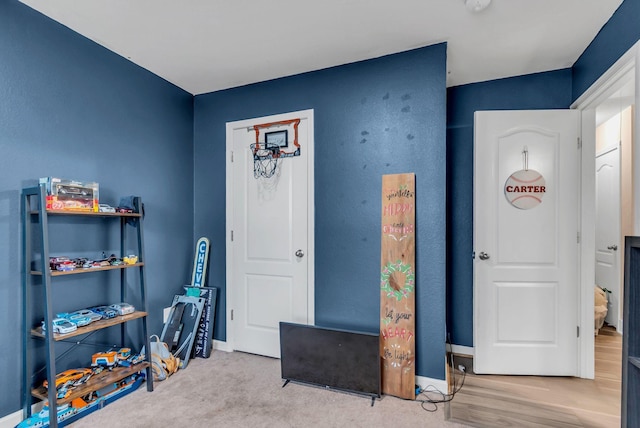 game room with light colored carpet