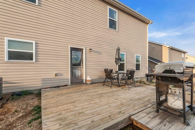 wooden terrace featuring a grill