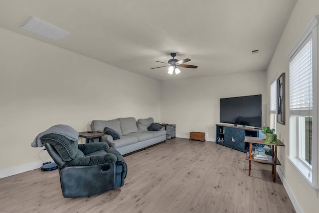 living room featuring ceiling fan and light hardwood / wood-style flooring