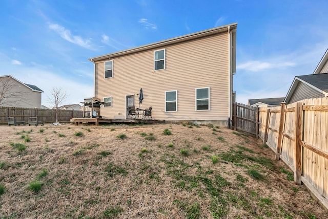 rear view of house with a wooden deck