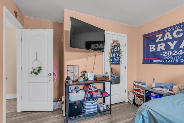 bedroom with wood-type flooring and a closet