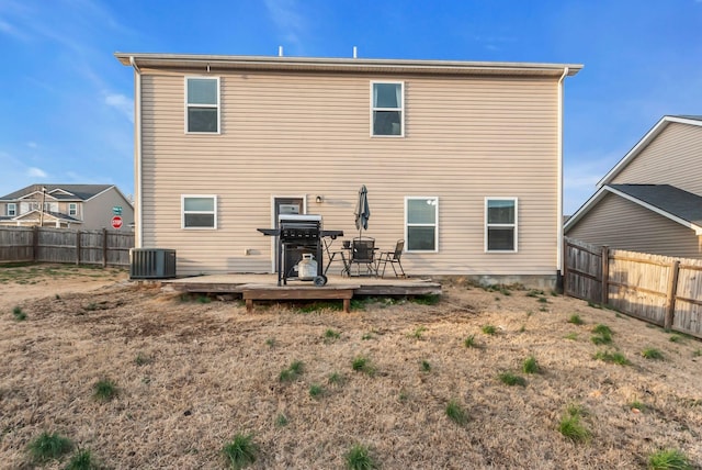 back of house featuring a deck and central AC unit