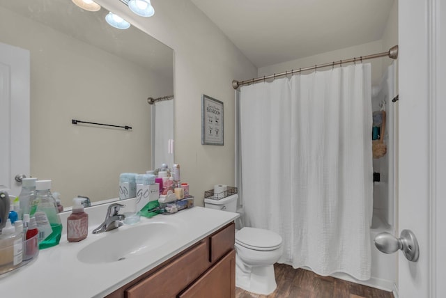 full bathroom with toilet, shower / tub combo with curtain, vanity, and hardwood / wood-style flooring