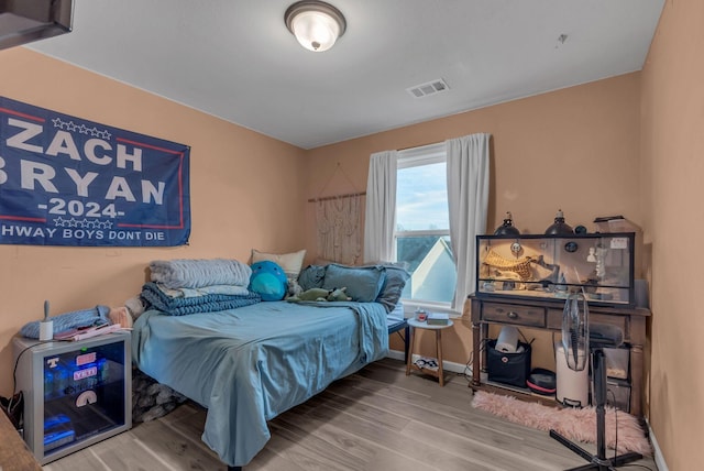 bedroom with hardwood / wood-style flooring