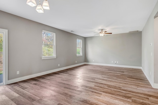 empty room with hardwood / wood-style flooring and ceiling fan