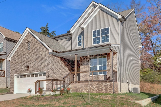 view of front of property featuring a front lawn, central AC unit, a porch, and a garage