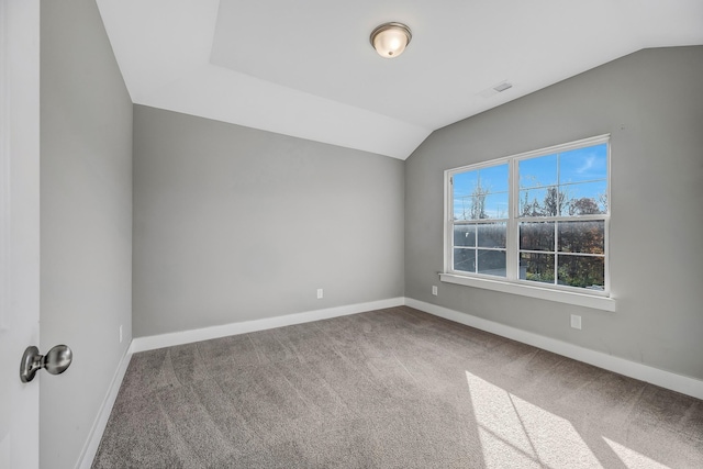 unfurnished room featuring carpet floors and vaulted ceiling