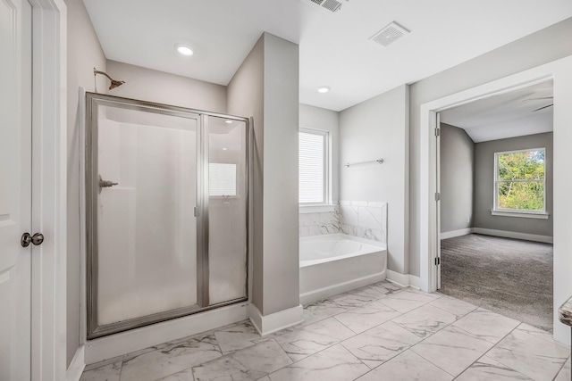 bathroom featuring shower with separate bathtub