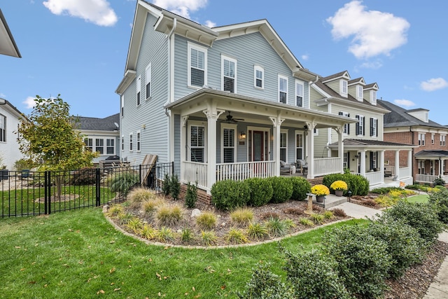 view of front of house featuring ceiling fan, a front lawn, and covered porch