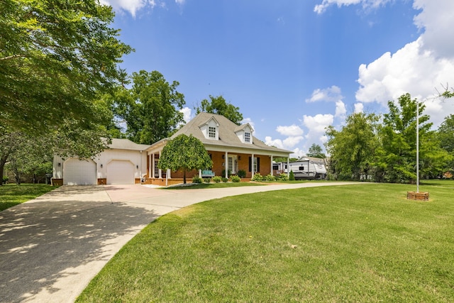 cape cod house featuring a front yard, a garage, and covered porch