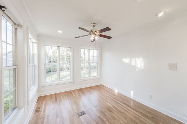 empty room featuring light hardwood / wood-style floors, ceiling fan, and crown molding