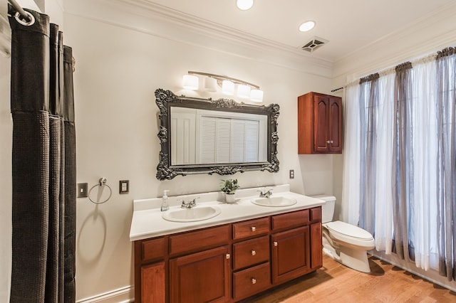 bathroom with vanity, hardwood / wood-style flooring, toilet, and ornamental molding