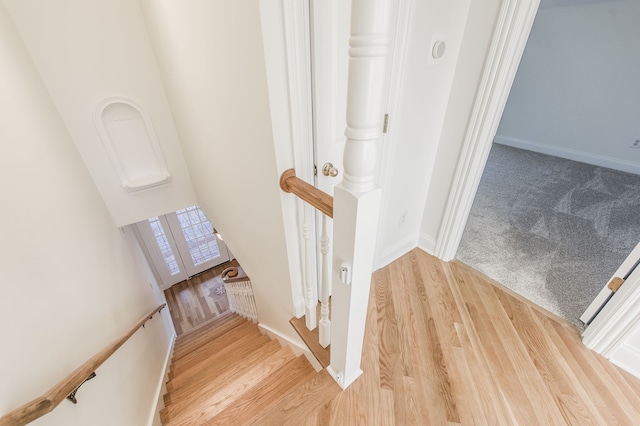 staircase with wood-type flooring