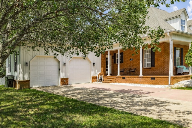 view of front facade featuring covered porch, a garage, and a front lawn