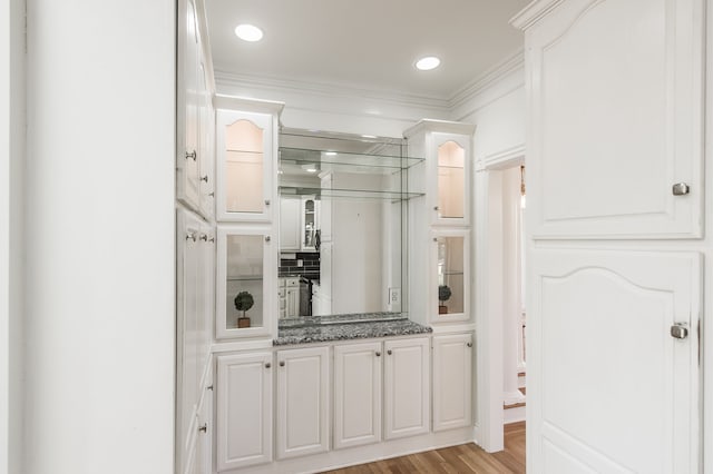 interior space featuring vanity, hardwood / wood-style flooring, and crown molding