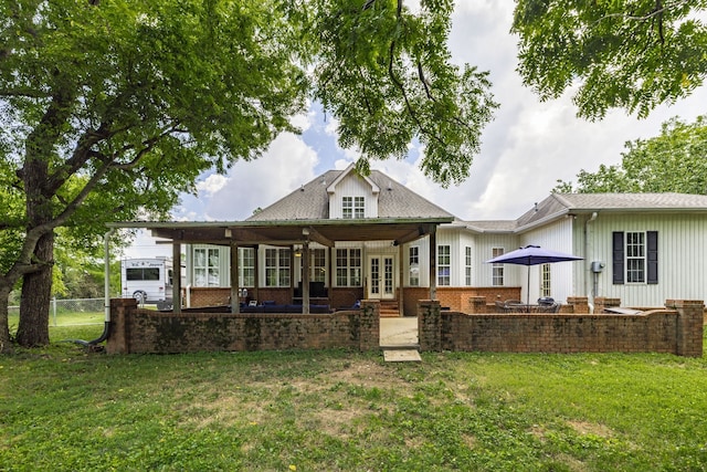 back of property featuring french doors and a yard