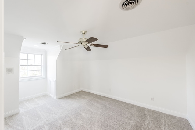 carpeted empty room with vaulted ceiling and ceiling fan