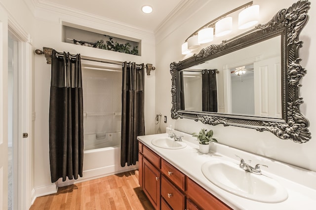 bathroom with hardwood / wood-style floors, vanity, shower / bathtub combination with curtain, and ornamental molding