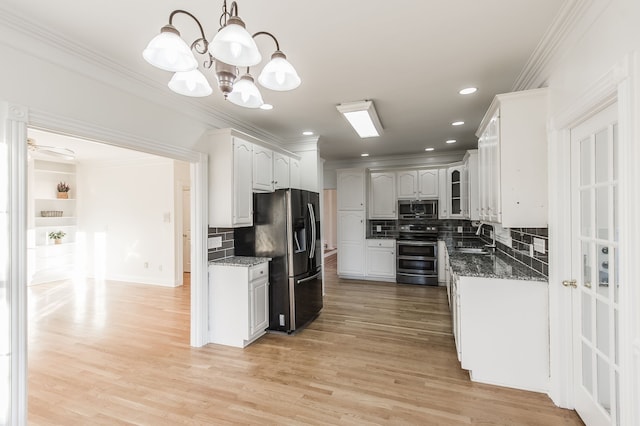 kitchen featuring sink, decorative backsplash, decorative light fixtures, white cabinetry, and stainless steel appliances