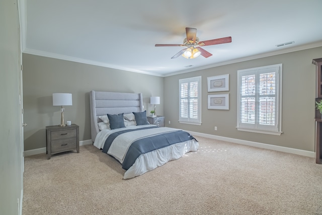 bedroom featuring ceiling fan, crown molding, and light carpet