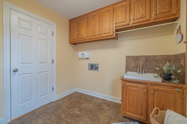 washroom with cabinets, hookup for a washing machine, and sink